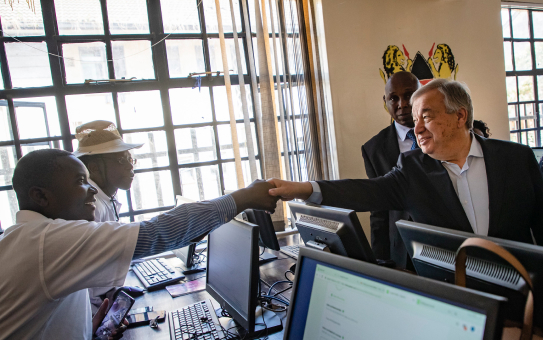 Secretary-General shakes hands with a man